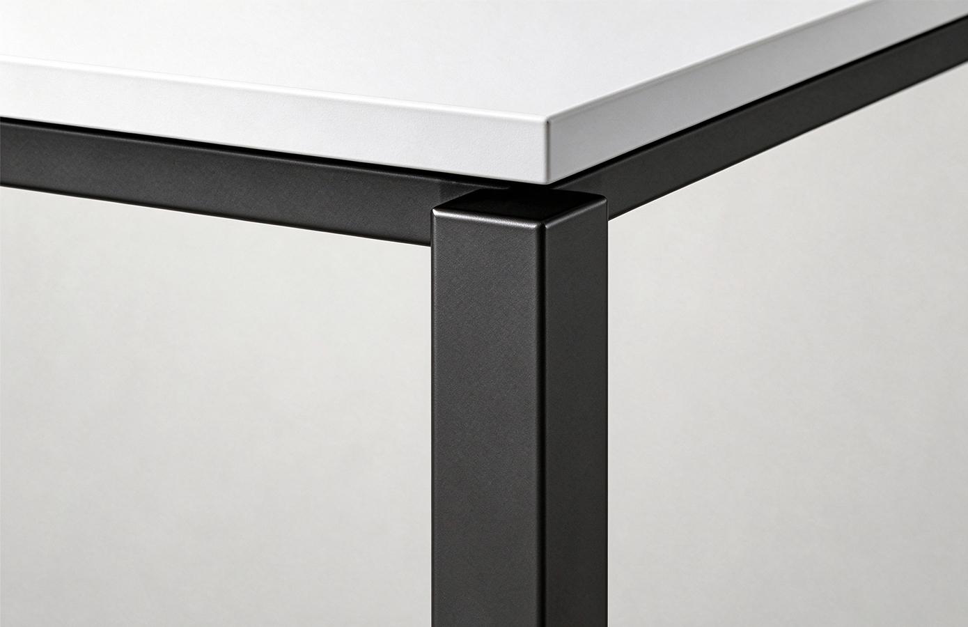 Close-up of the desktop edge and black metal frame