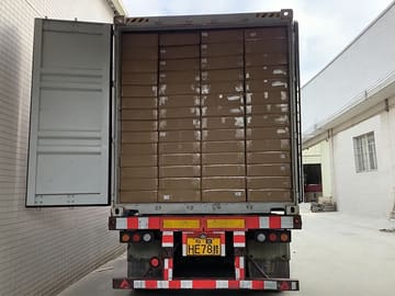Shipping container fully loaded with packed furniture cartons