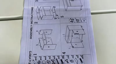 Assembly instruction sheet being reviewed during quality control