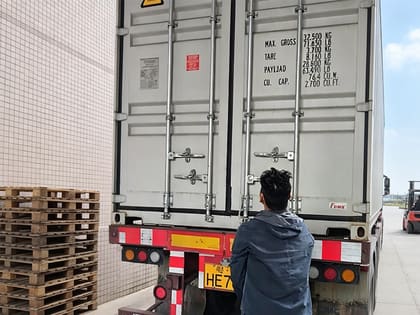 Container number and order details being verified before loading